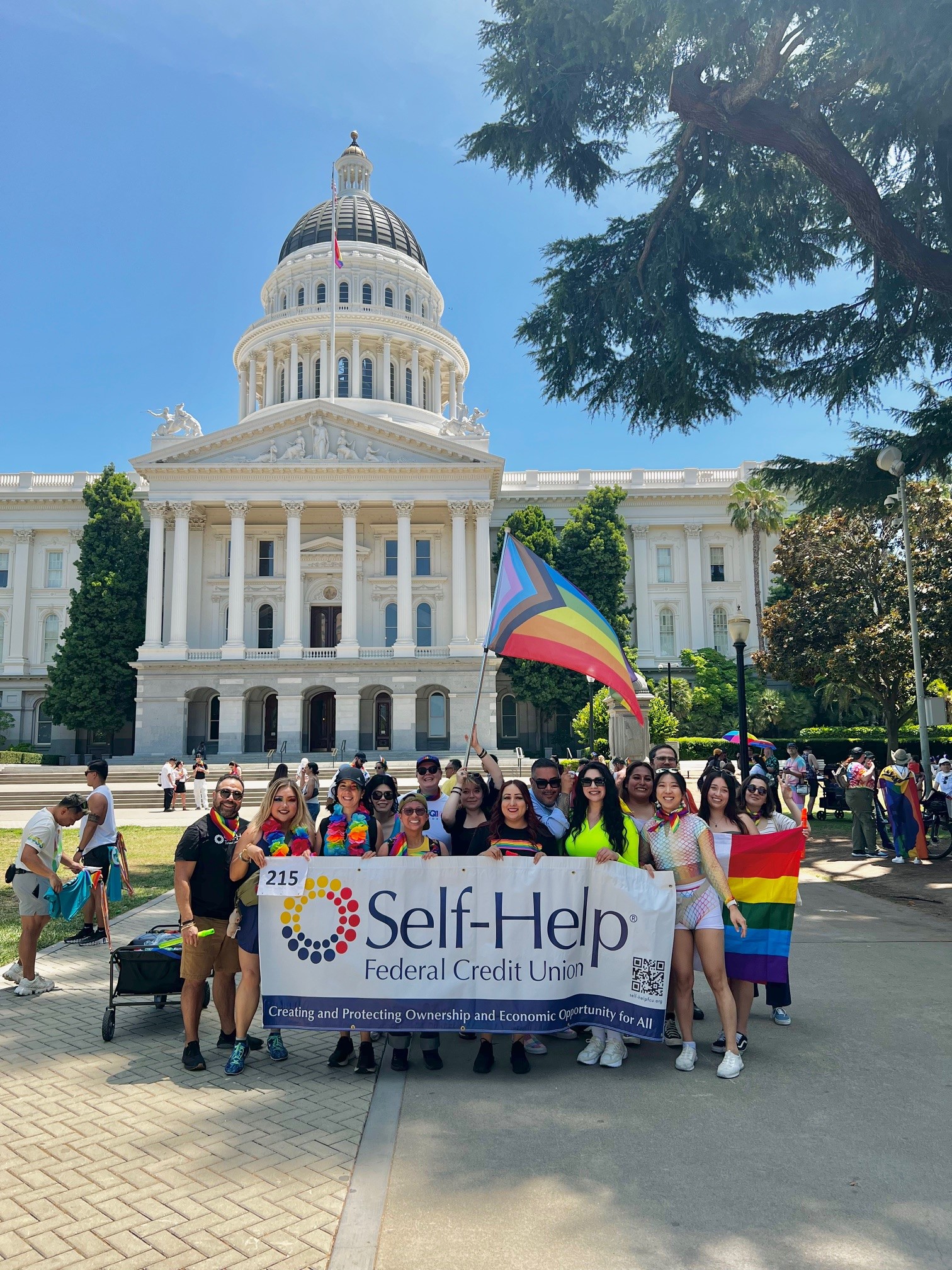 Self-Help Staff holding a banner that reads
